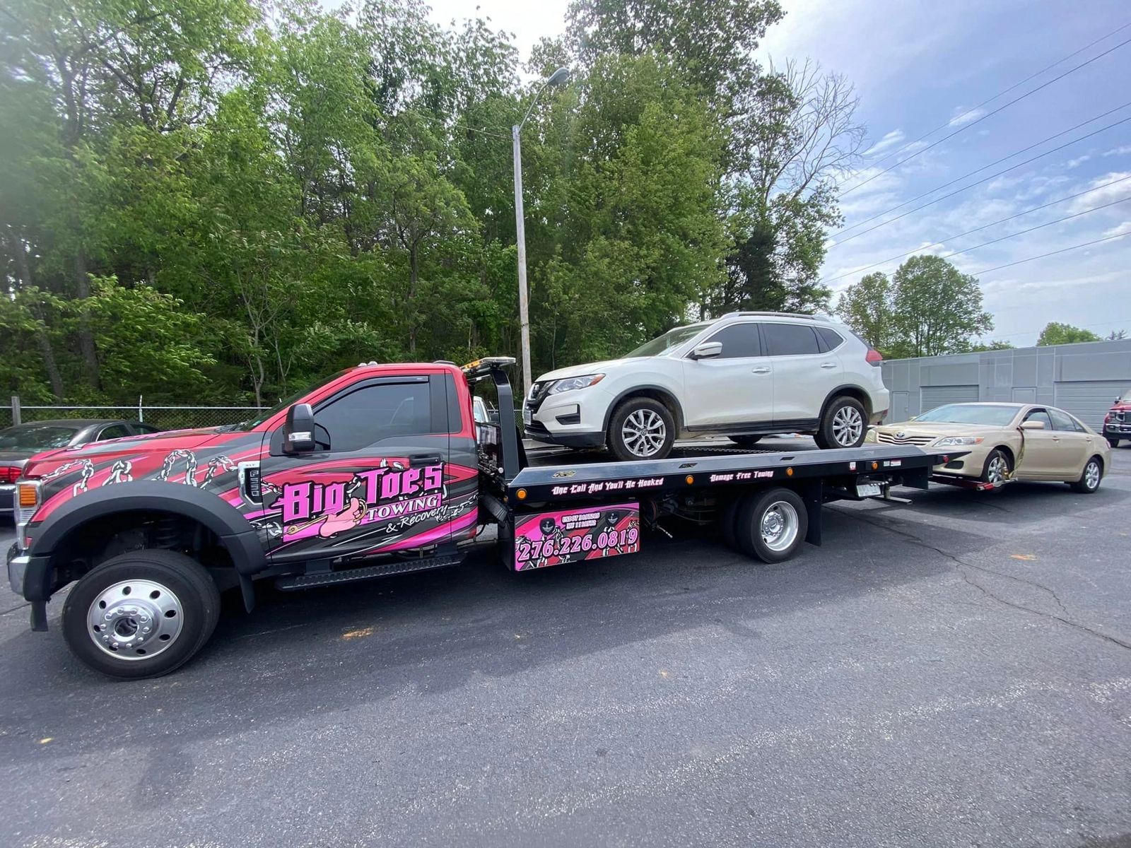 Big Toe's flatbed hauling a classic Camaro damage-free